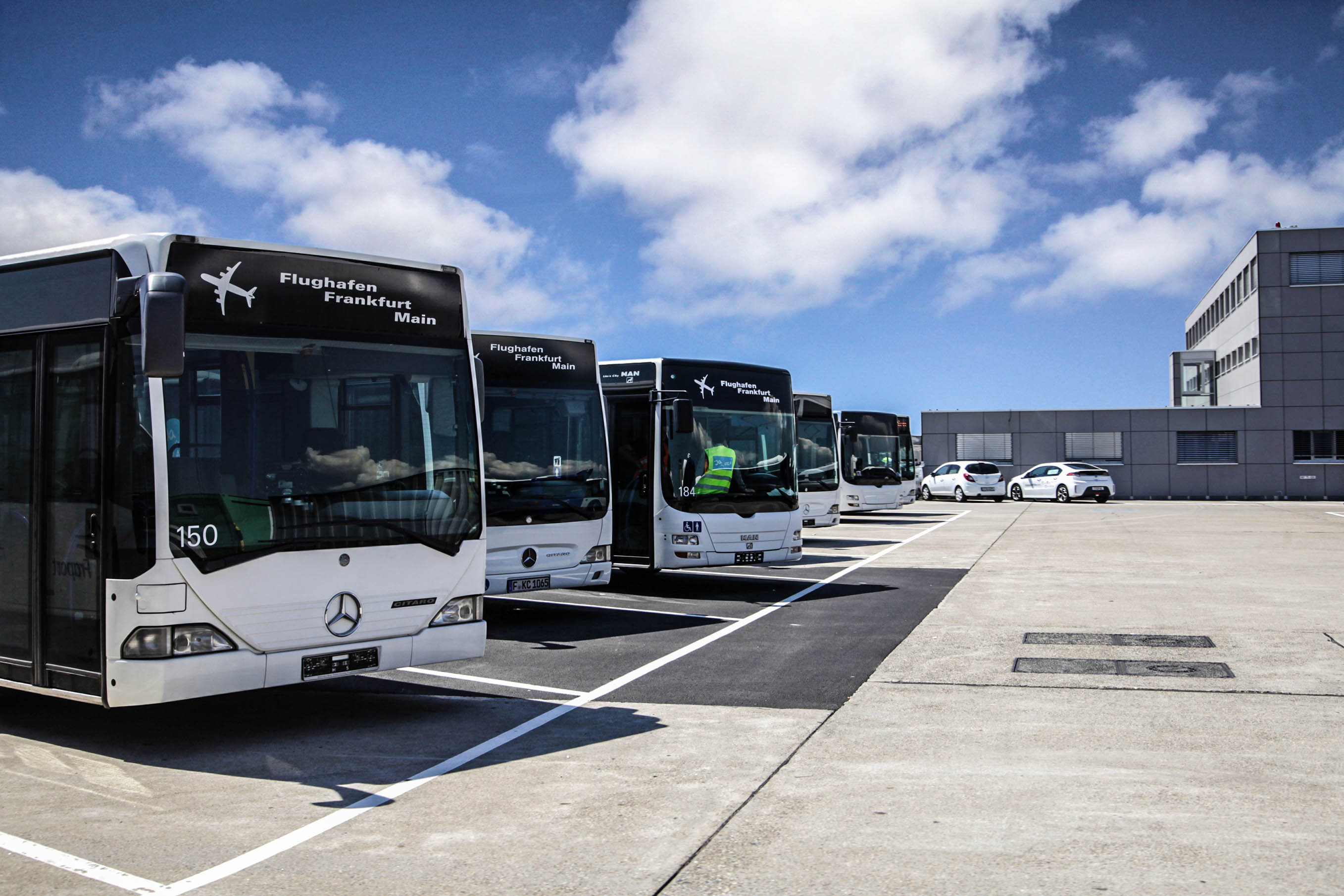 Frankfurt, Germany - August 20, 2015: A row of Mercedes Benz shuttle buses is waiting to be asked to take flight passengers from concorses to external airliner parking positions on the airfield.