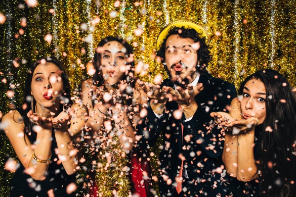 Friends blowing confetti on New Year's Eve - 2016.