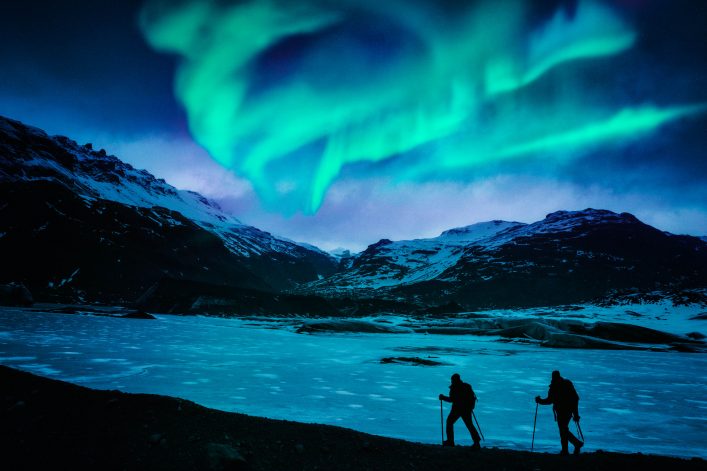 Hikers Under the Northern Lights
