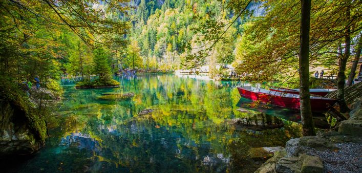 yellow-leaves-and-red-boat-at-blausee-blue-lake-nature-park-kandersteg-switzerland-shutterstock_127214768-2