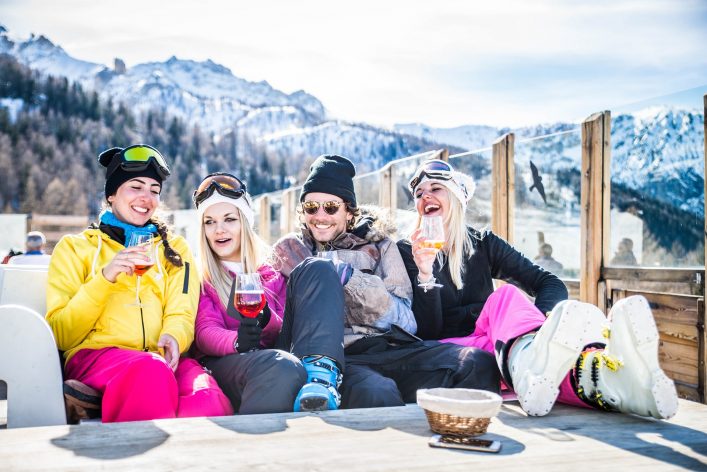 Group-of-friends-talking-and-having-fun-in-a-outdoor-restaurant-on-winter-holidays-shutterstock_618462353-1