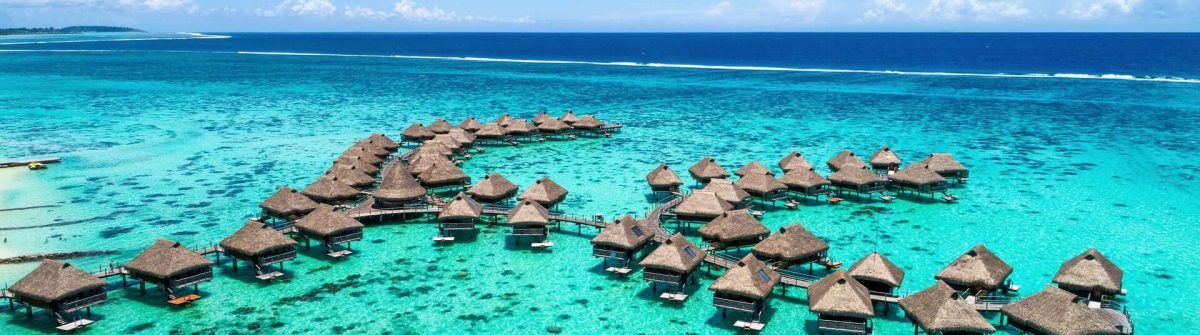Beach-travel-vacation-Tahiti-hotel-overwater-bungalows-luxury-resort-in-coral-reef-lagoon-ocean.-Moorea-French-Polynesia-Tahiti-South-Pacific-Ocean.-shutterstock_722048578