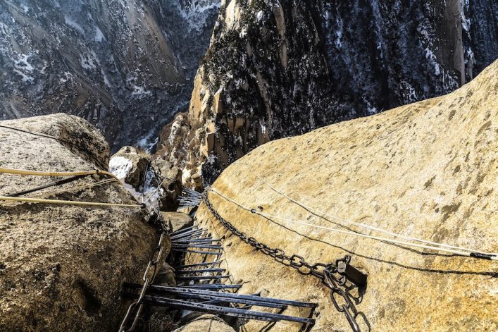 chains-and-metal-ladder-going-down-at-the-south-peak-of-huashan-mountain-shutterstock_374117227-2