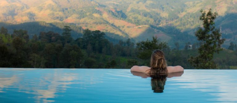 infinity-pool-woman-mountains_shutterstock_1722194287